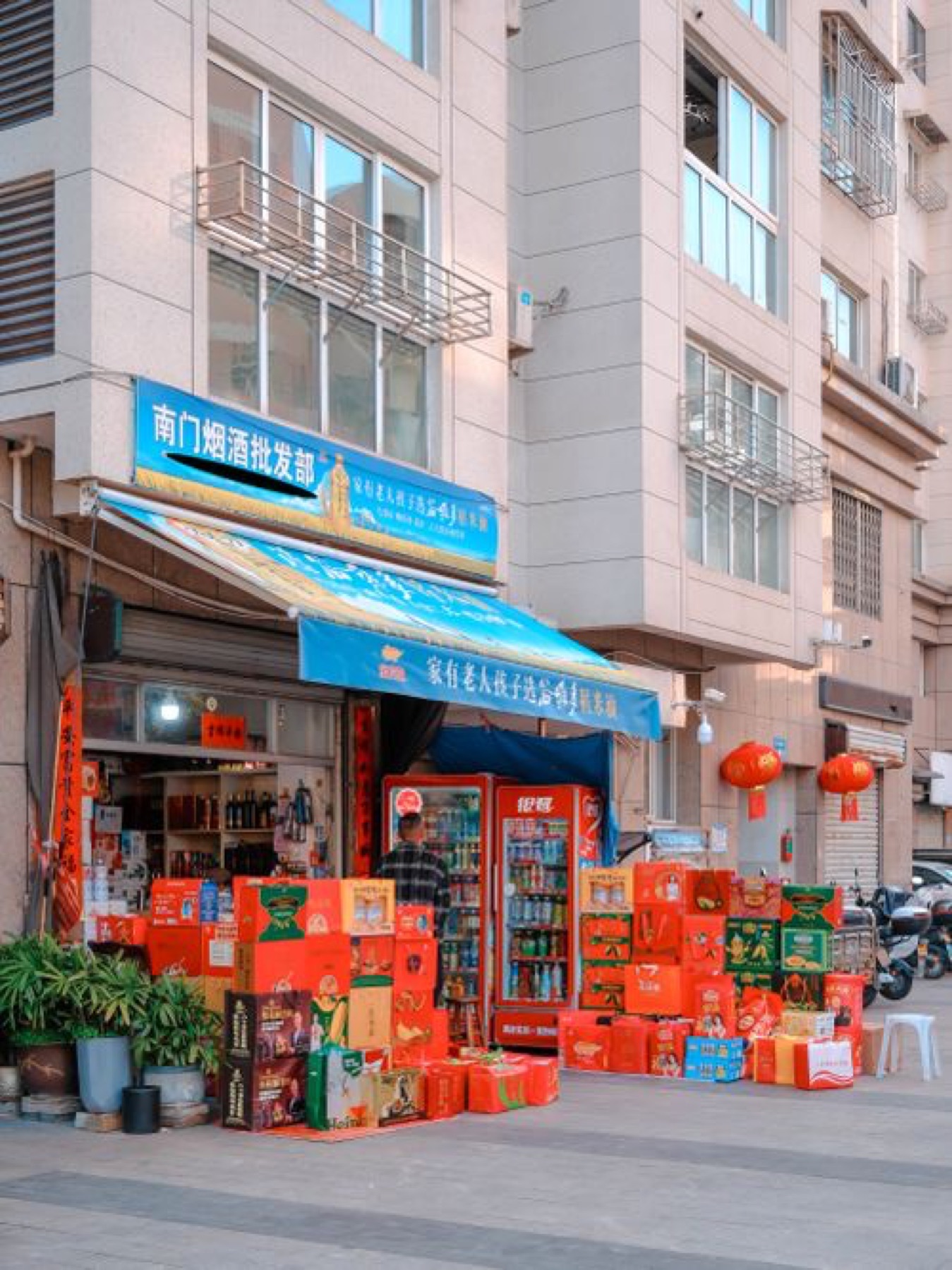 Busy Chinese wholesale market with goods displayed and lanterns overhead