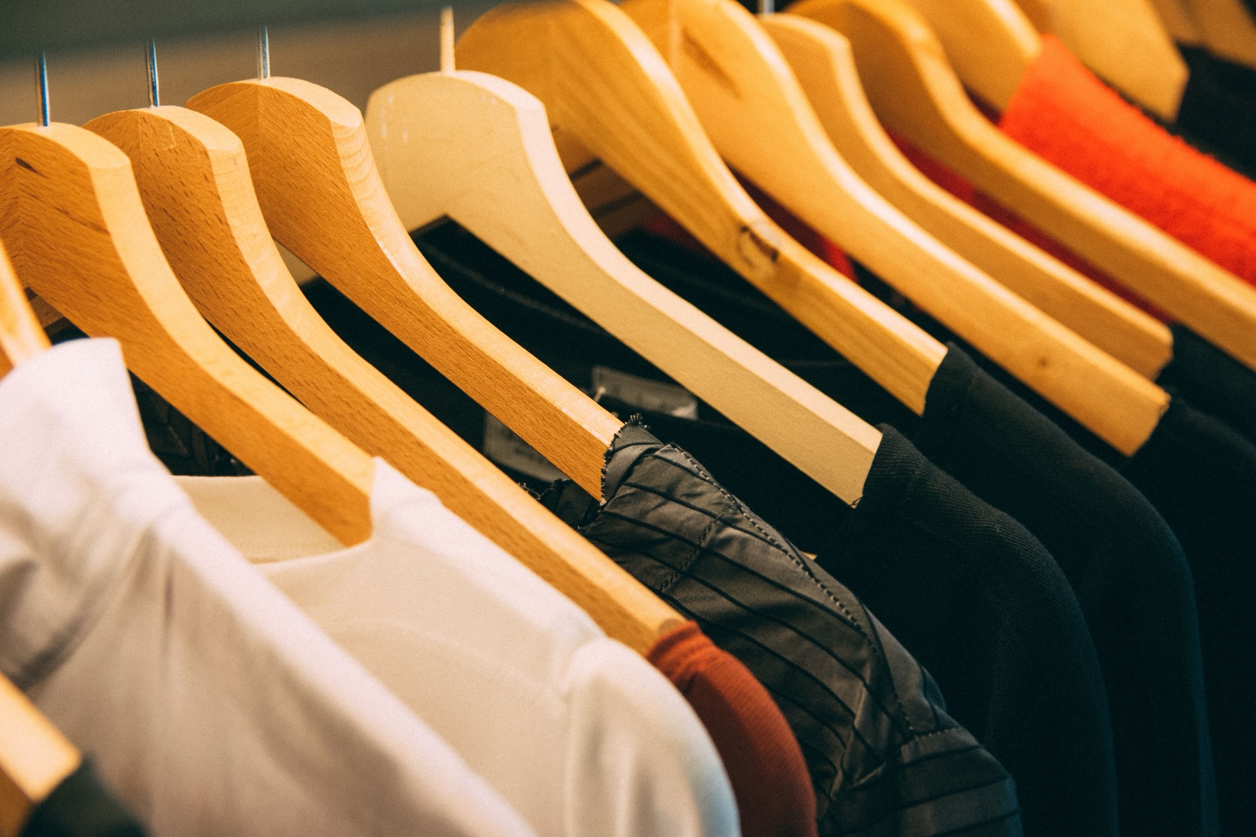 Assorted clothes hanging on a rack