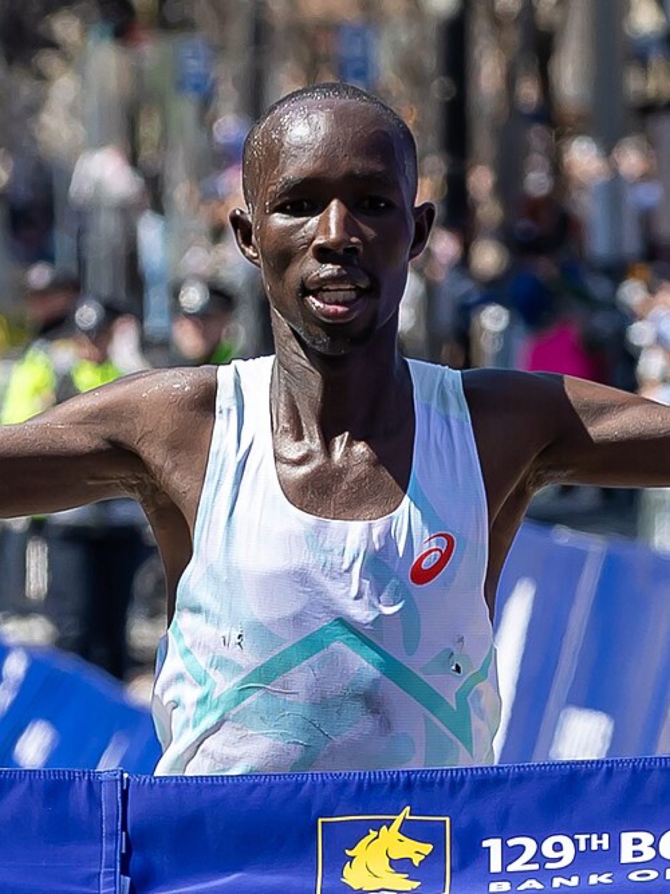 Runner crossing a finish line at a major race
