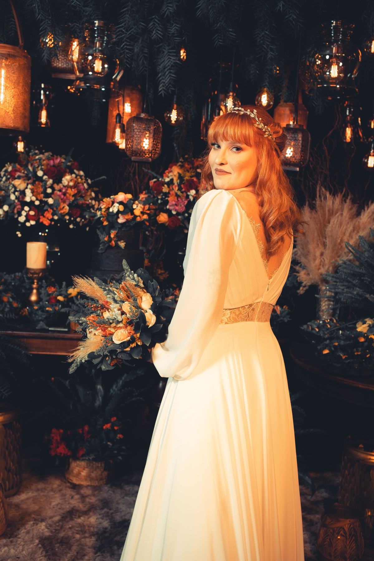 Woman in vintage-style dress browsing clothing racks, representing sourcing 1940s wedding dresses