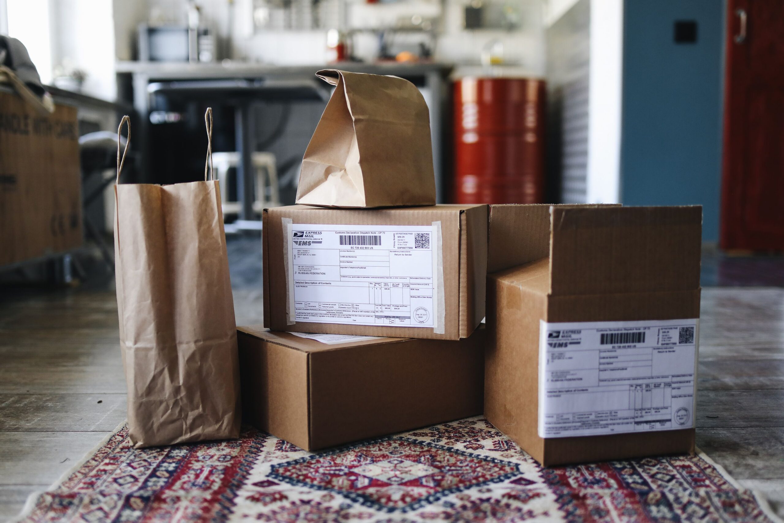 Close-up of cardboard boxes and bubble wrap on a packing table, illustrating packaging quality checks