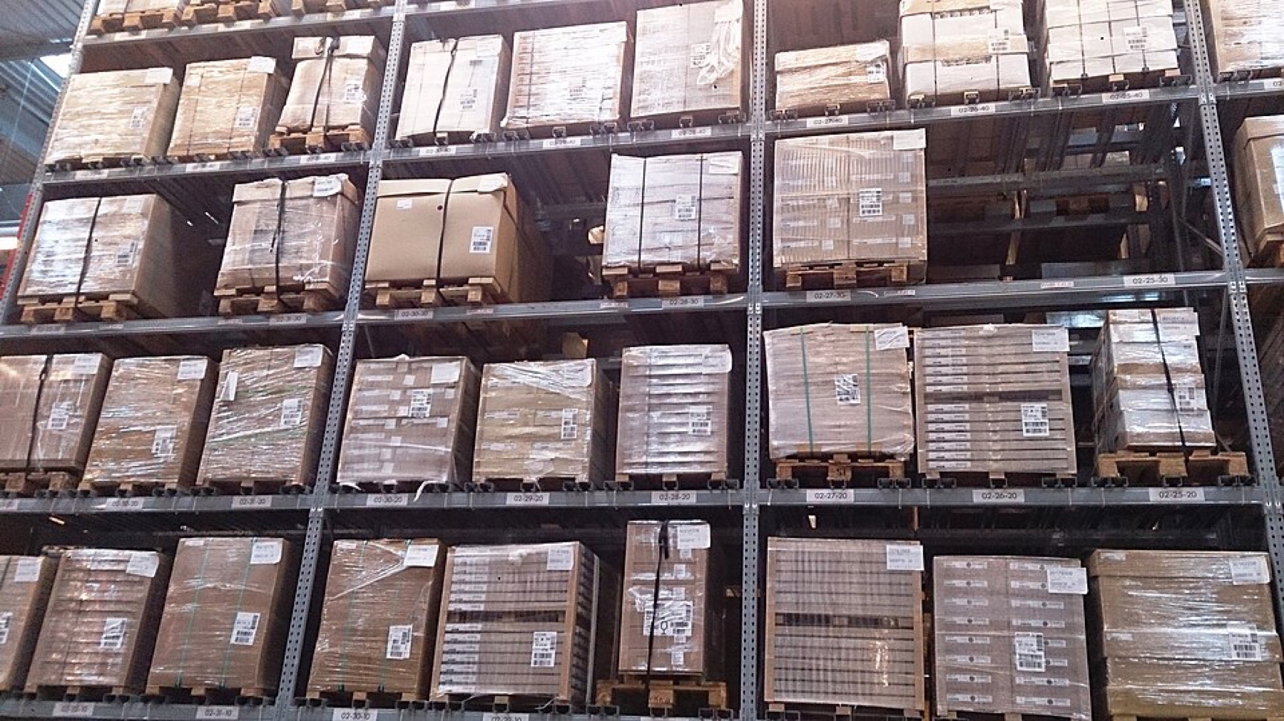 Shelves of boxed goods stacked in a warehouse environment