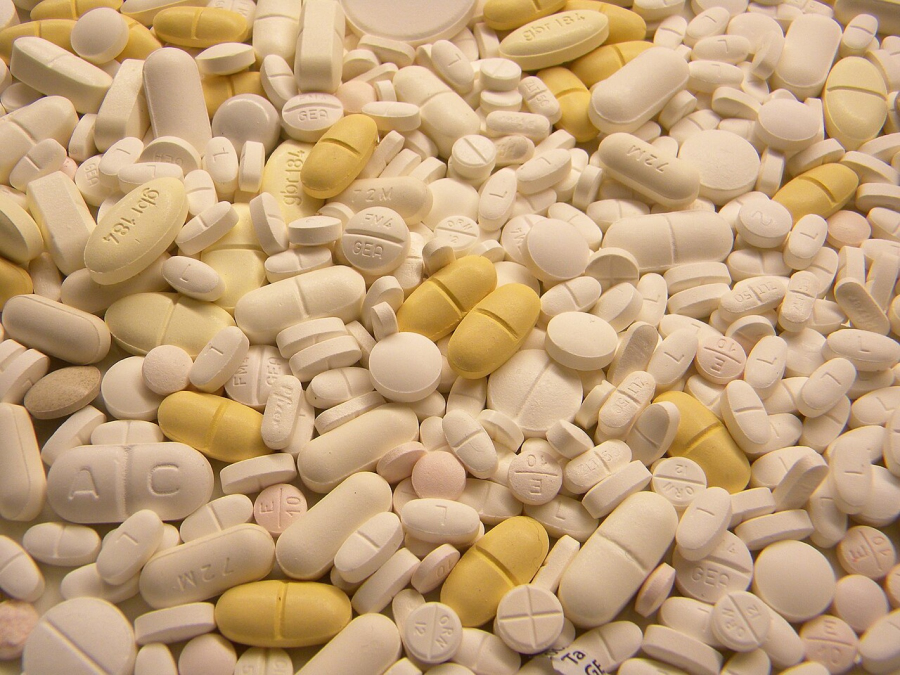 Mixed tablets and capsules illustrating products that need packaging and organizers