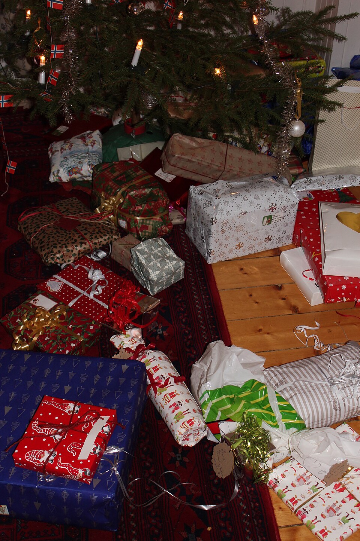 Assorted Christmas gifts arranged under a tree