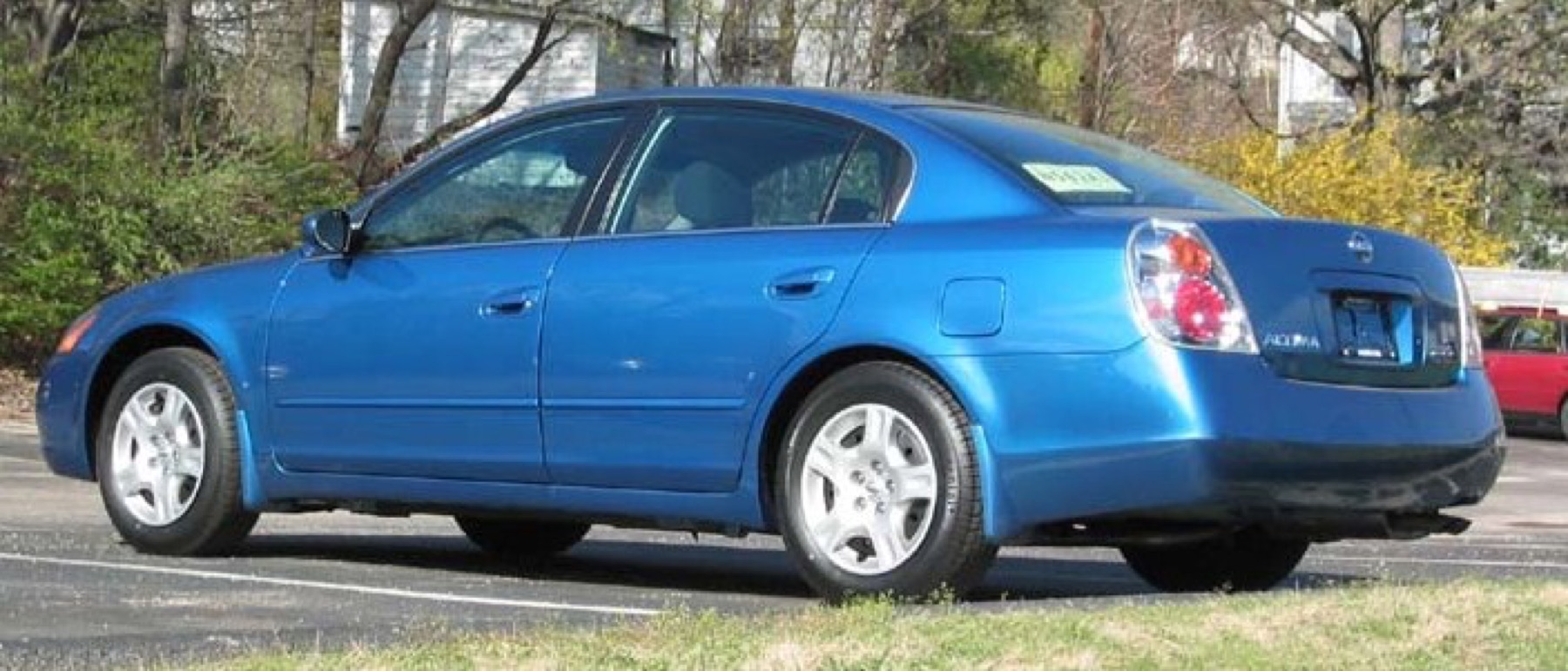 Rear view of a Nissan Altima showing factory tail light assemblies