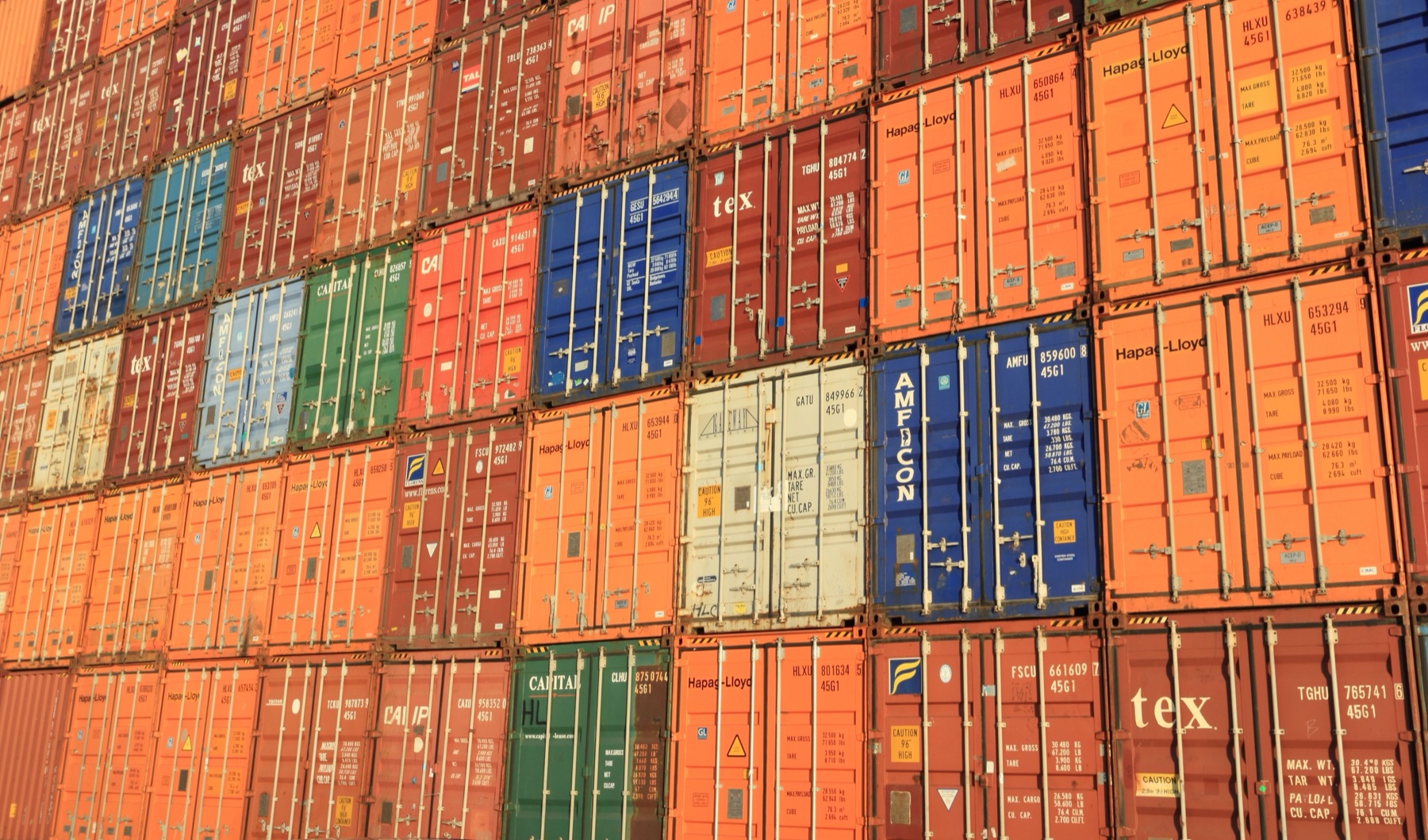 Shipping containers at an international port representing cross-border wholesale logistics and risk