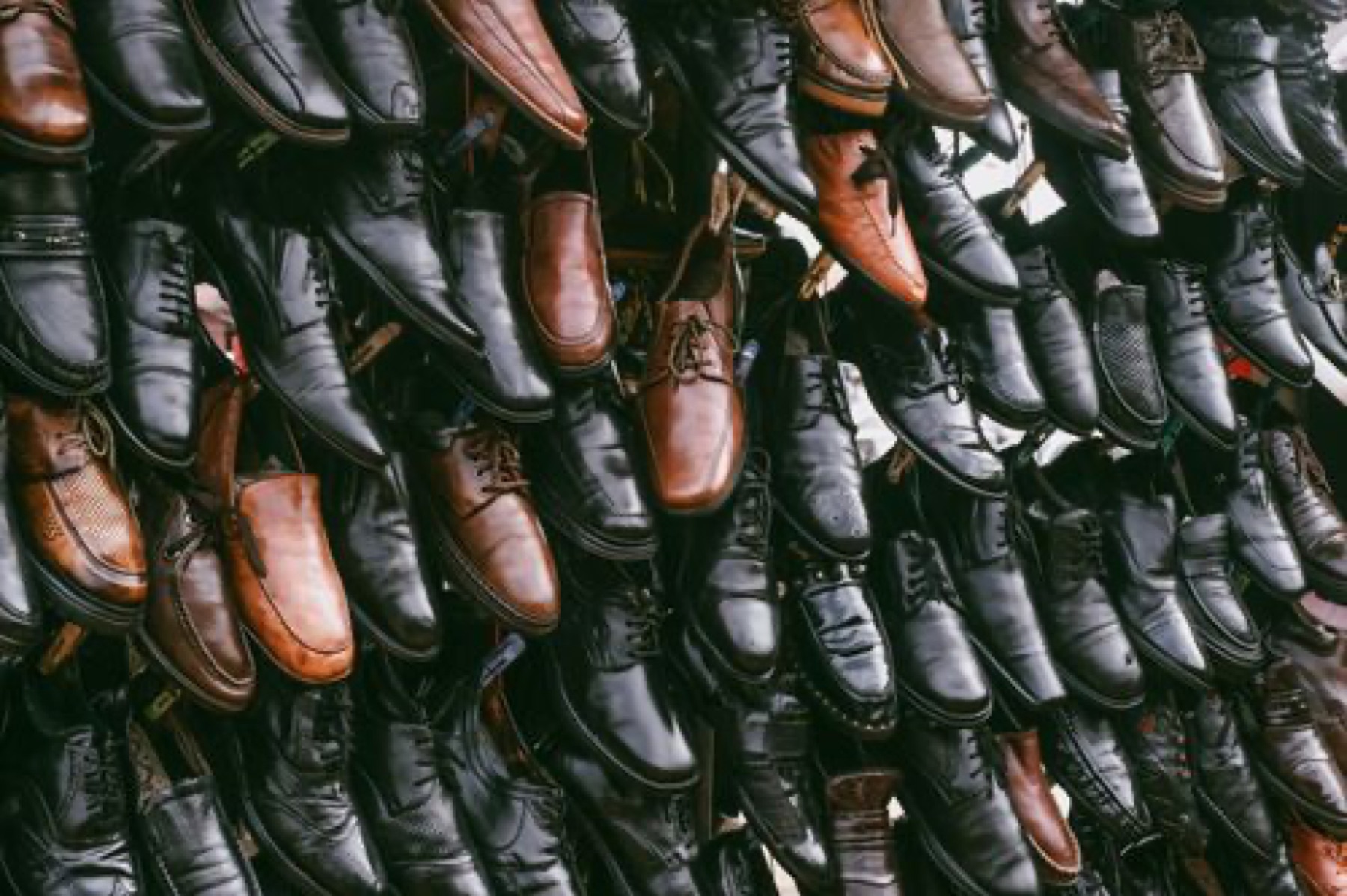 Wall display of assorted leather shoes in a wholesale store