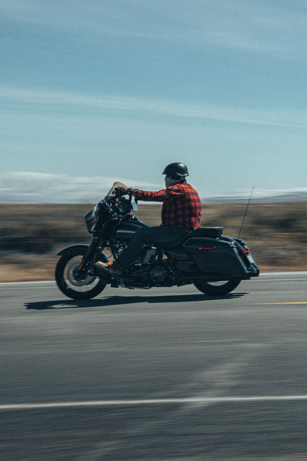 Motorcycle rider on road, representing real-world safety decisions