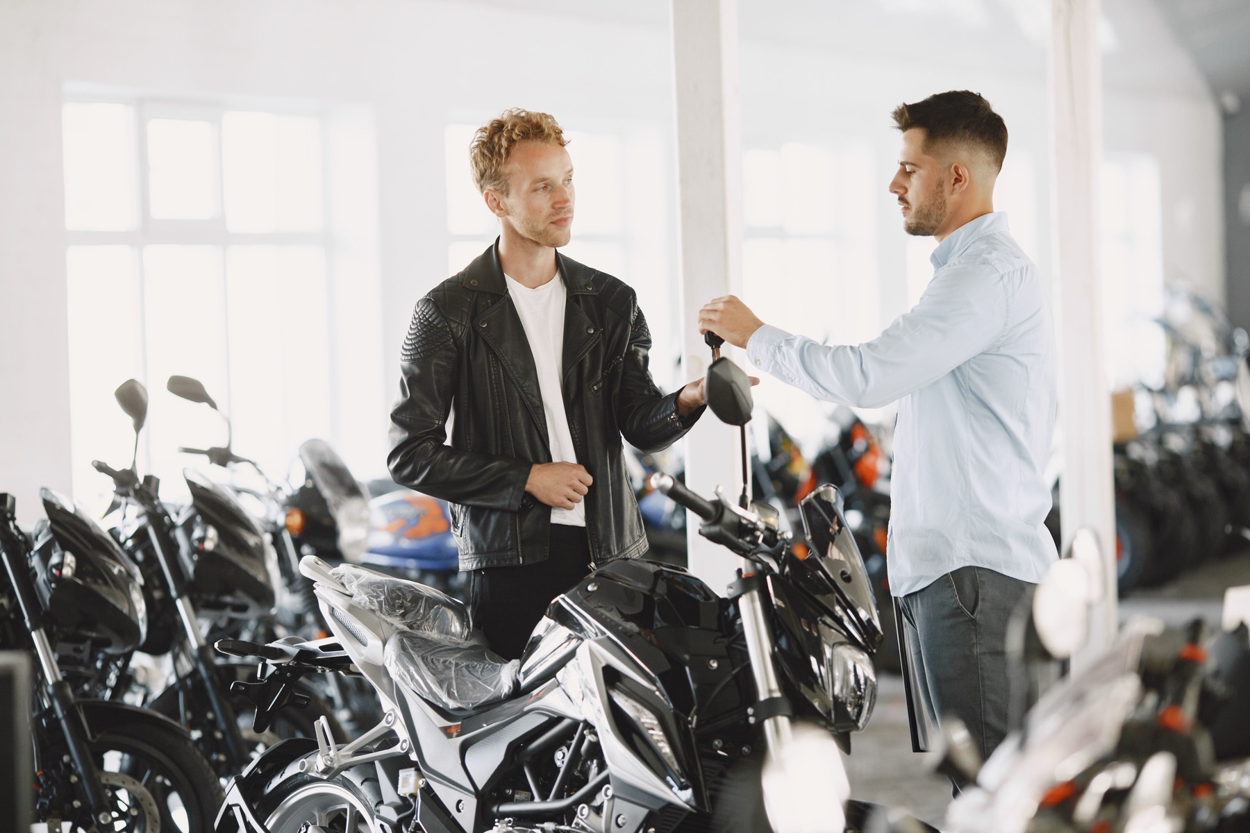 Motorcycle buyer reviewing sourcing options on a laptop
