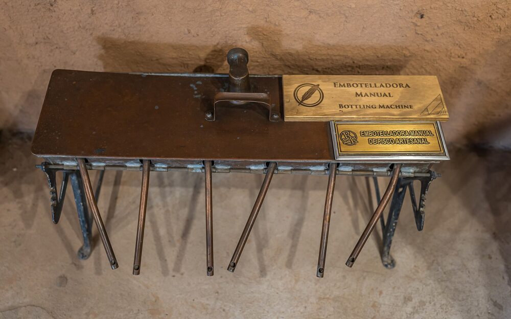 Manual bench-top filling machine on a small production table