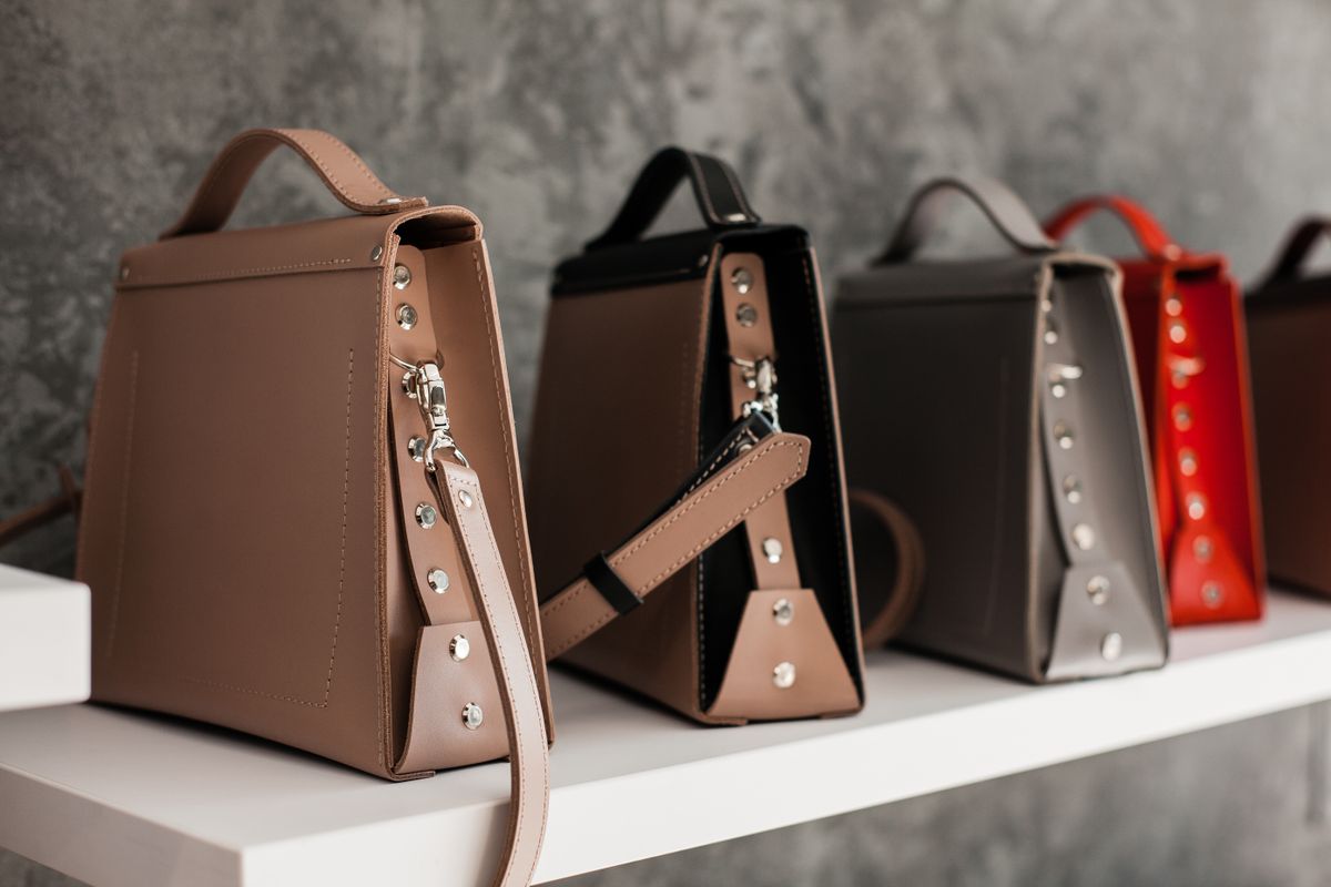 Several handbags displayed on a shelf