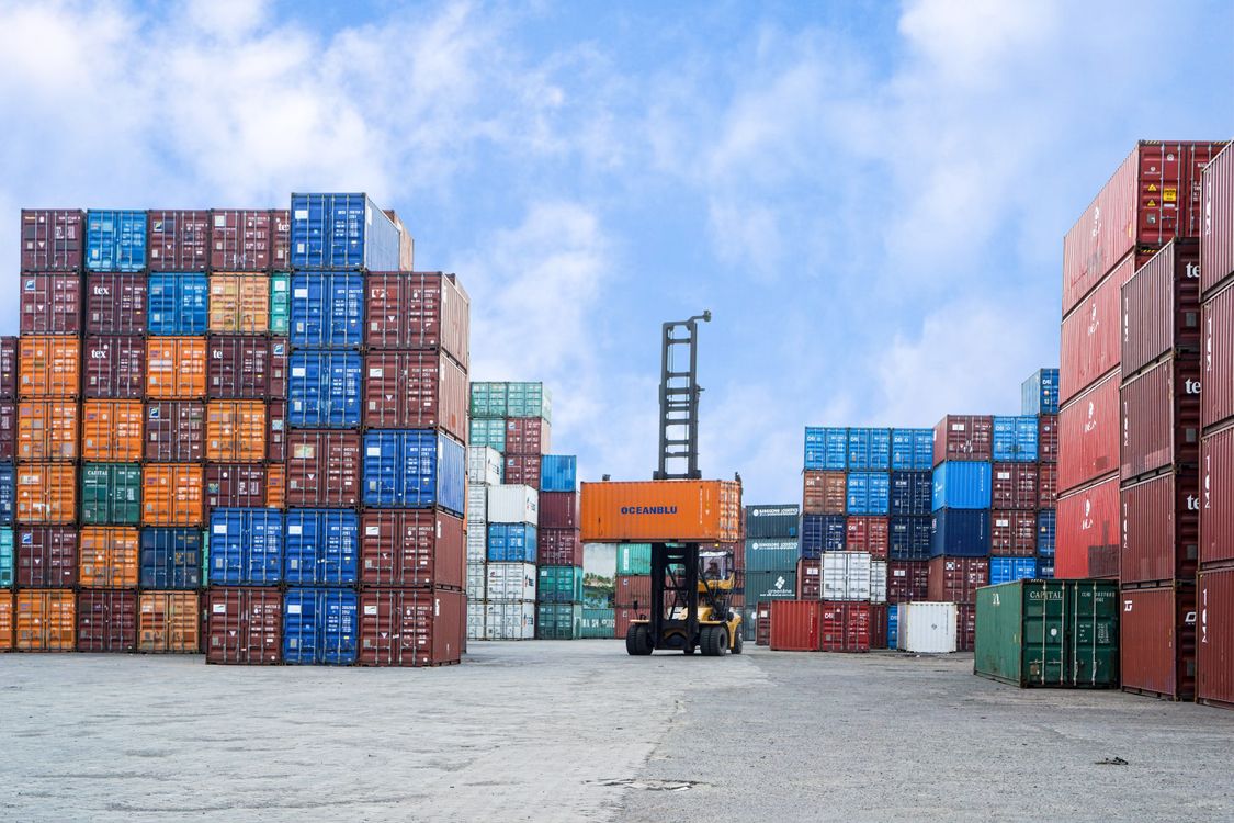 Colorful shipping containers and a forklift at a Jakarta port