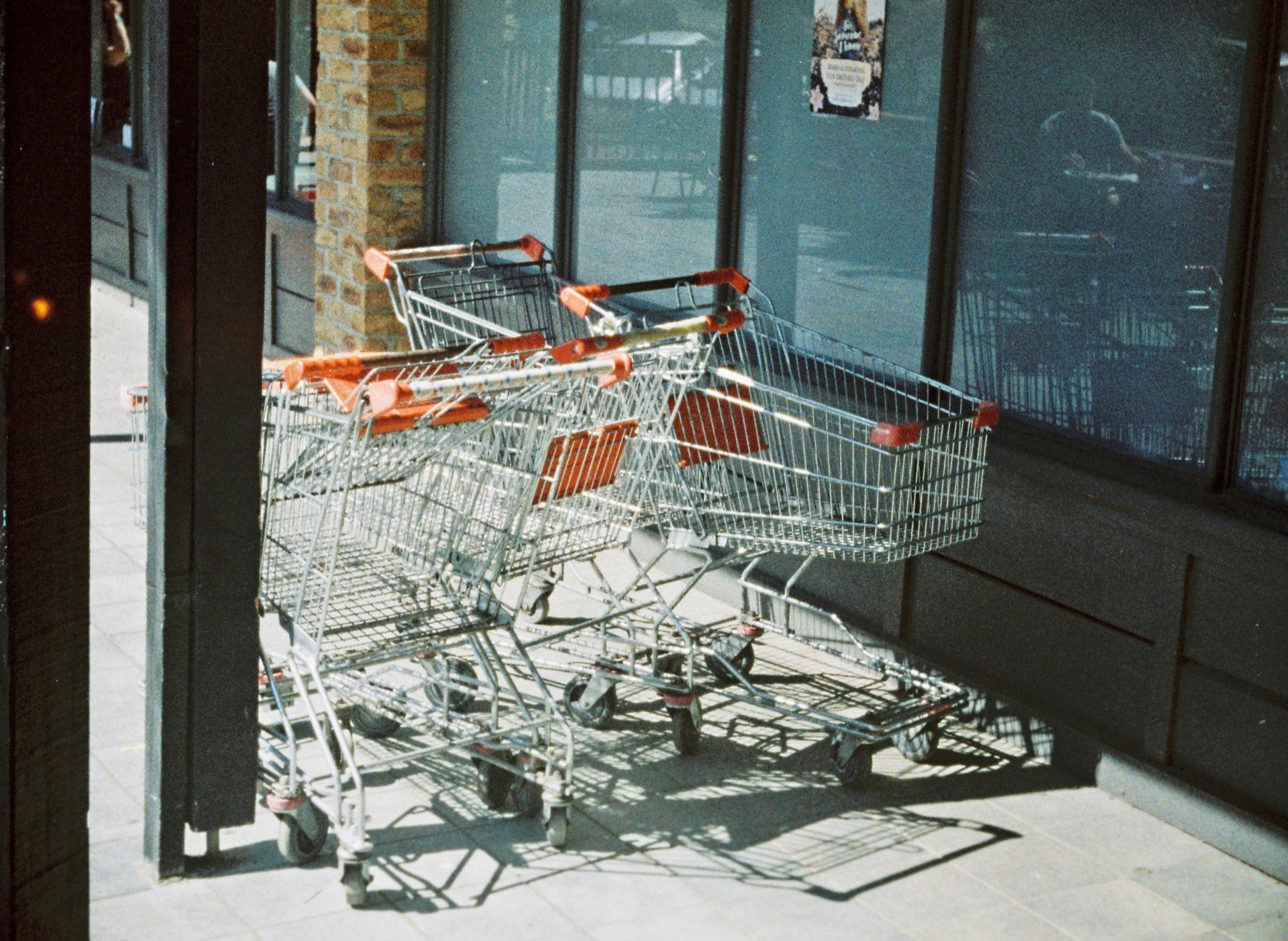 Row of shopping trolleys outside an Australian supermarket, representing multi-mart price comparison