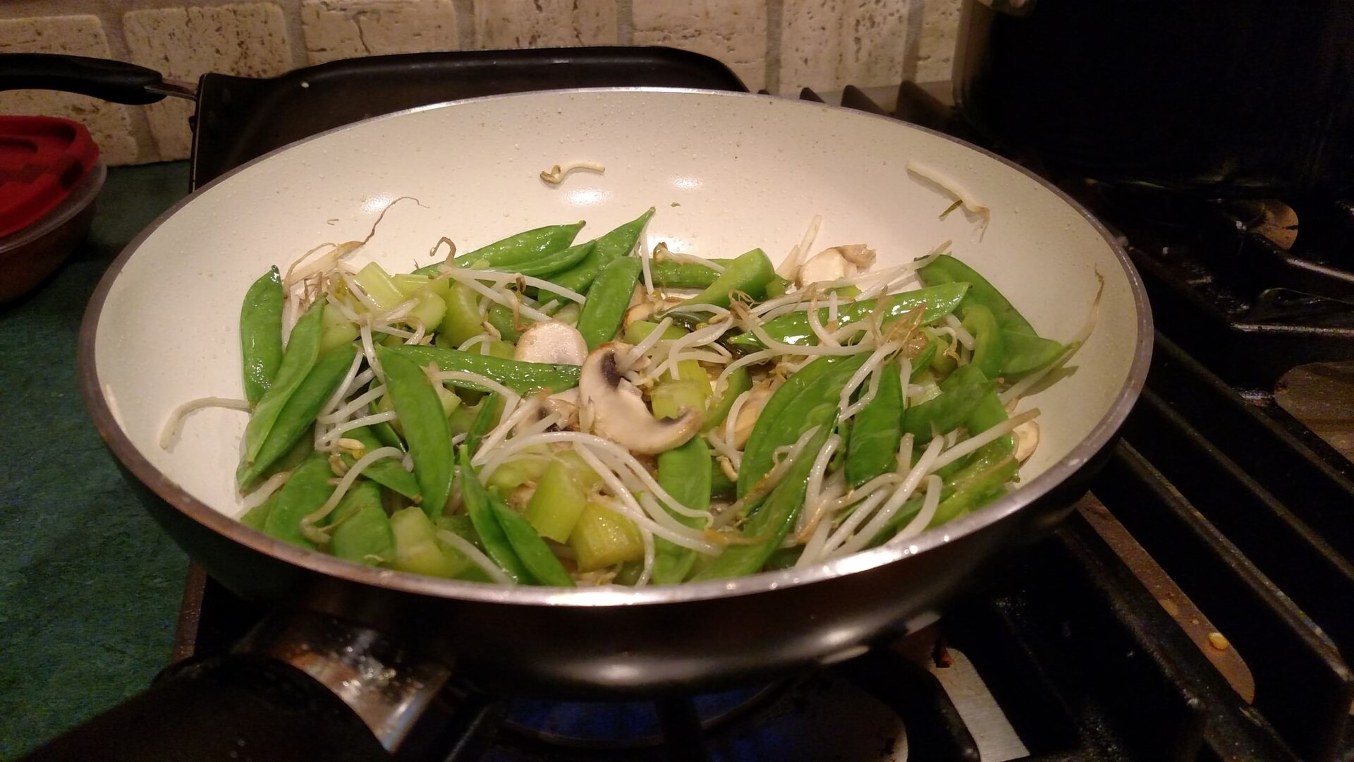Vegetables cooking in a wok, illustrating the wide bowl used for stir-frying