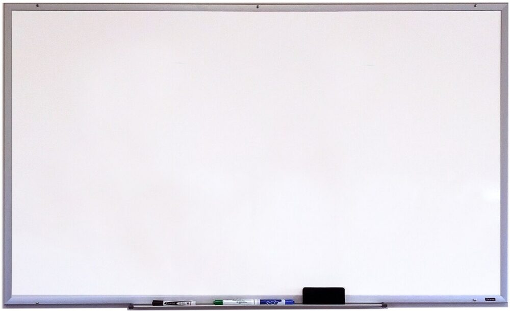 Whiteboard with dry-erase markers and an eraser arranged on its tray.