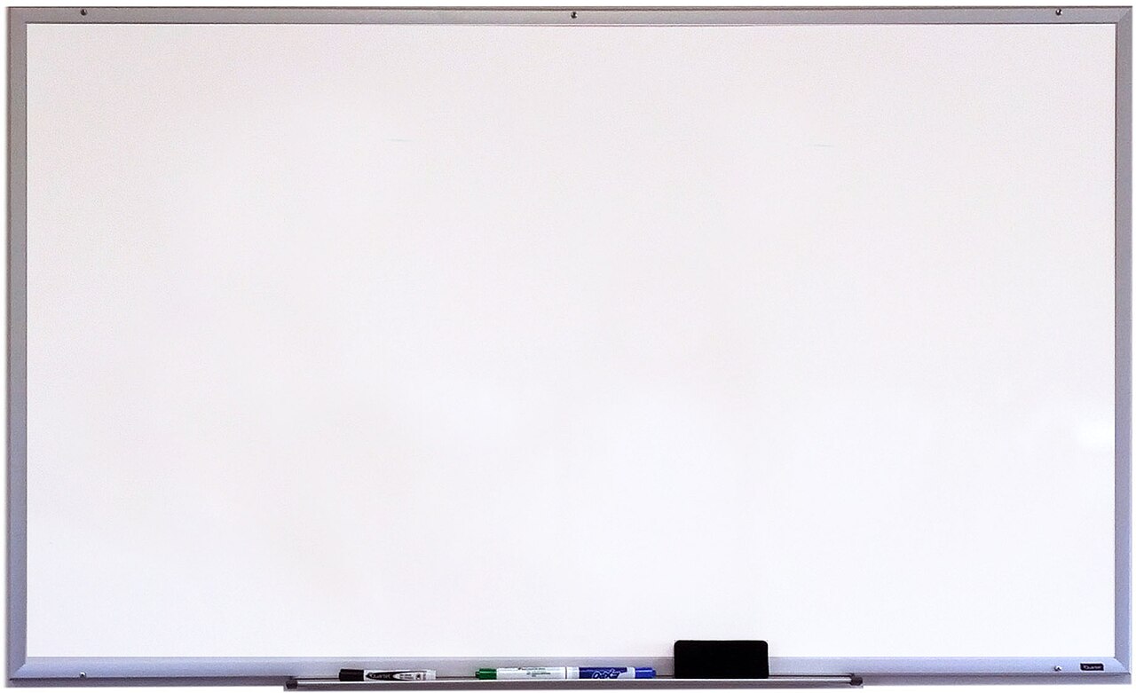 Whiteboard with dry-erase markers and an eraser arranged on its tray.