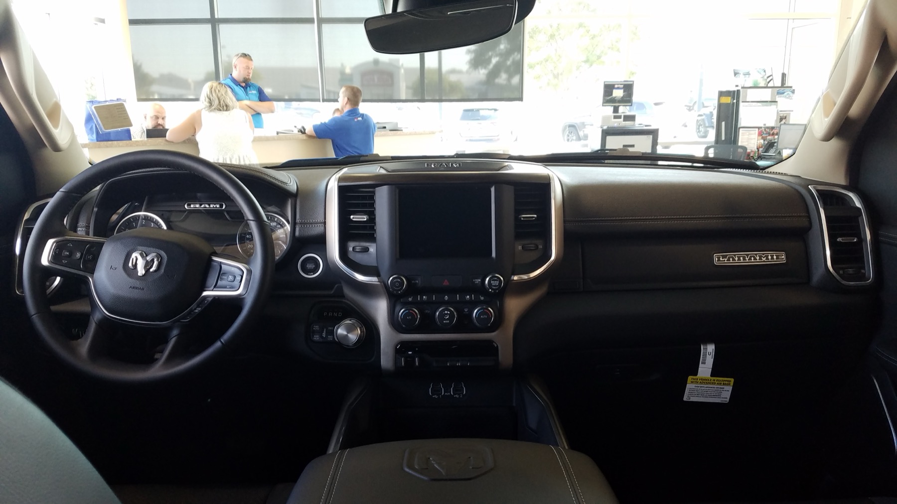 Interior of a 2021 Ram 1500 showing the center console and armrest