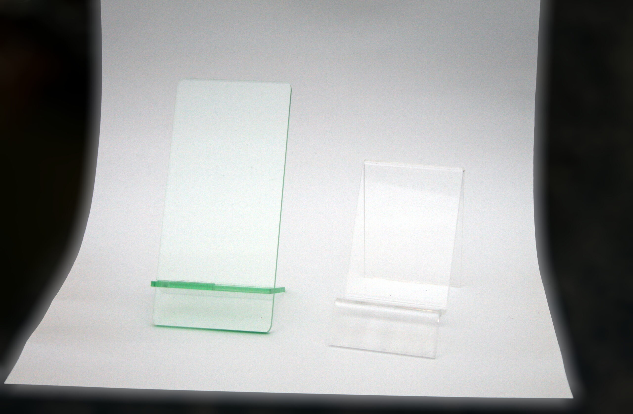 Two clear acrylic stands showing material clarity and bent construction relevant to small display fixtures