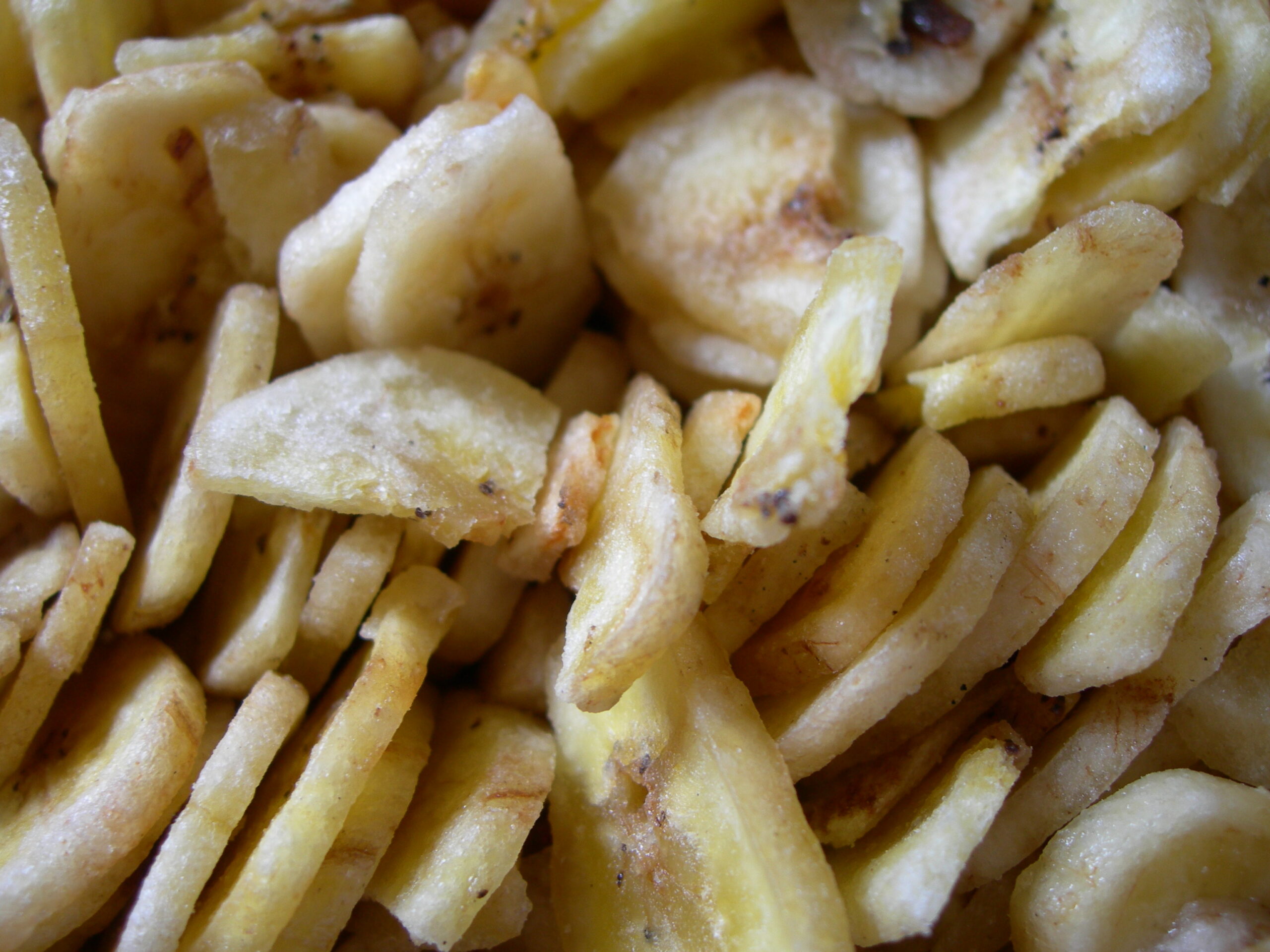 A large pile of bulk banana chips showing typical size and appearance