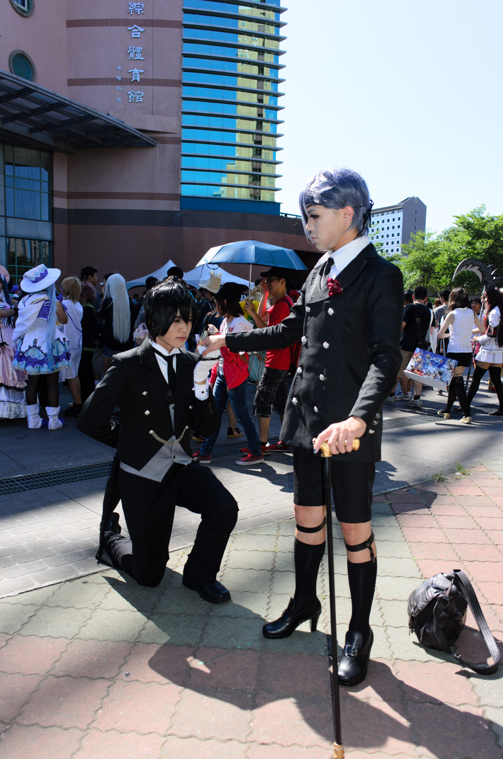 Cosplayers portraying Ciel Phantomhive and Sebastian Michaelis, showing character-specific costume details collectors may compare with a figure