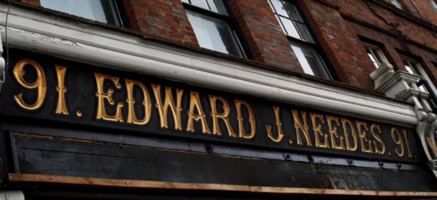 Carved wooden sign showing finish and lettering details