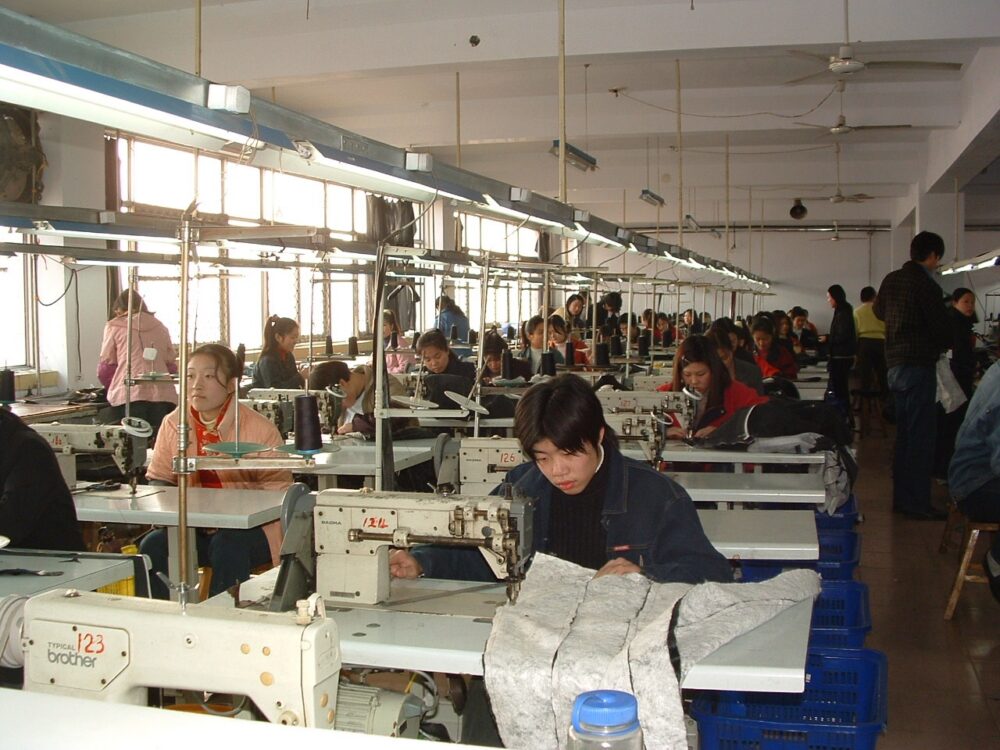 Leather garment factory workers making coats in Xinji, Hebei, China