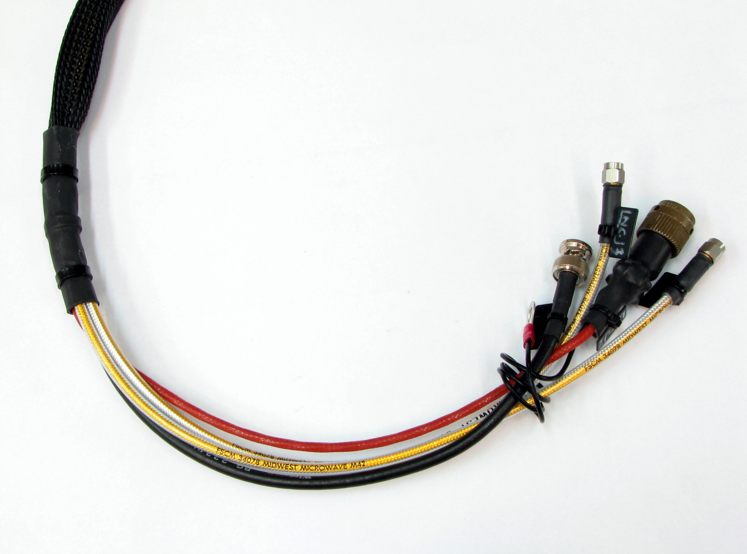 A bundled harness of coaxial cables ending in several connector types