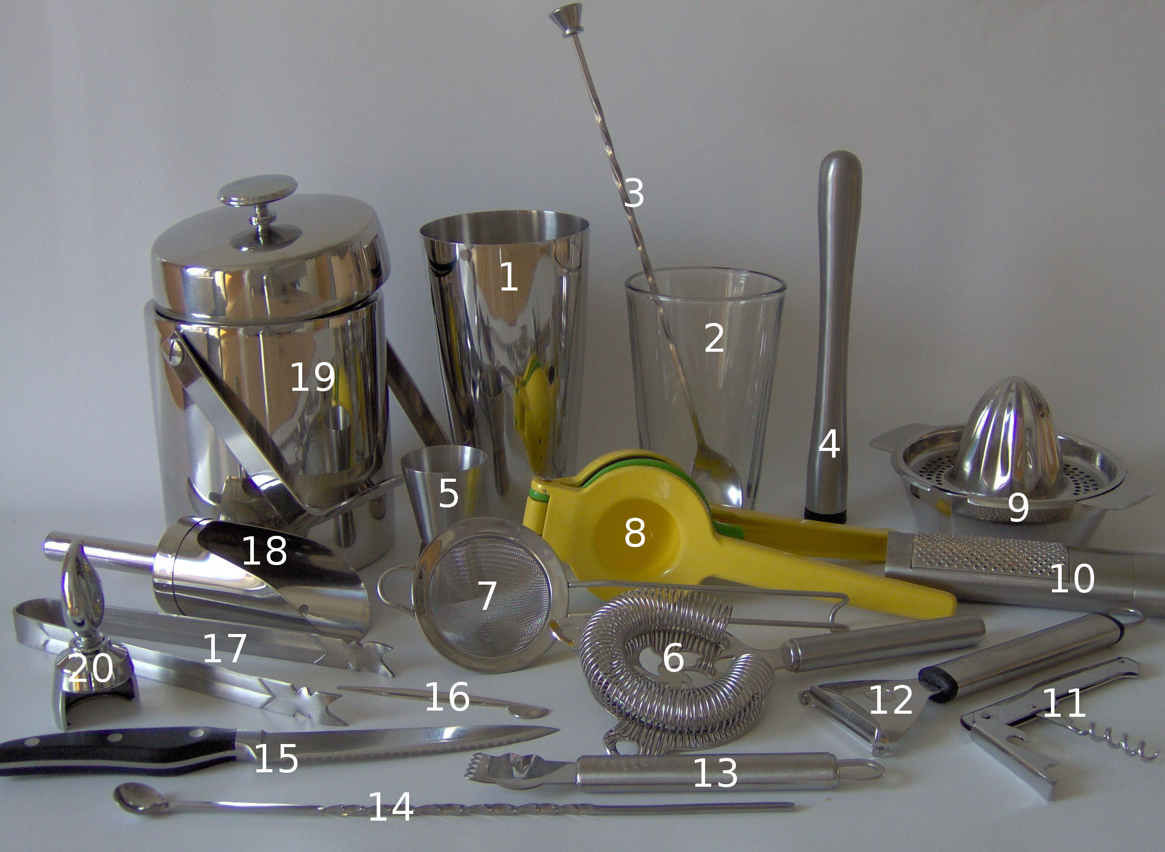 Assorted cocktail picks and bar tools on a bar counter