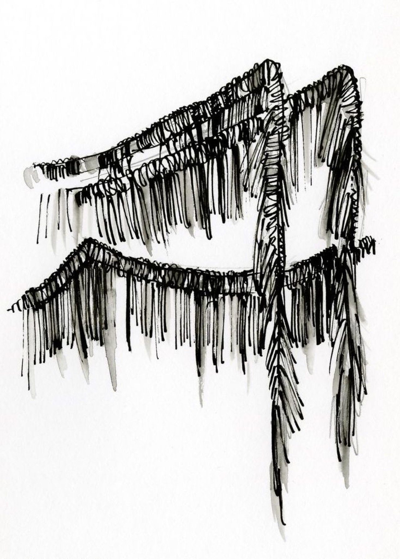 Fabric fringe draped over a chair, showing strand length and edge construction