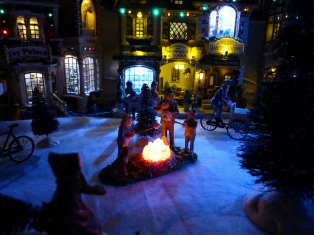 Lemax Christmas village buildings displayed on a table, illustrating the collectible nature of Lemax Christmas pieces.