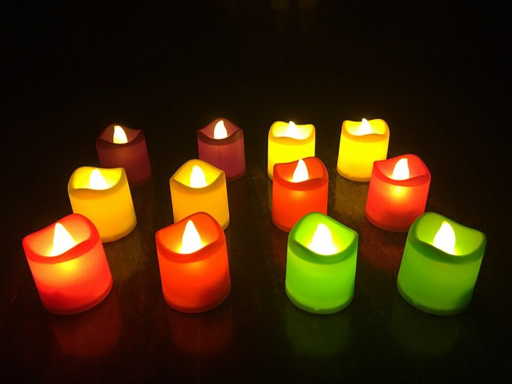 LED tea lights and candles glowing on a table
