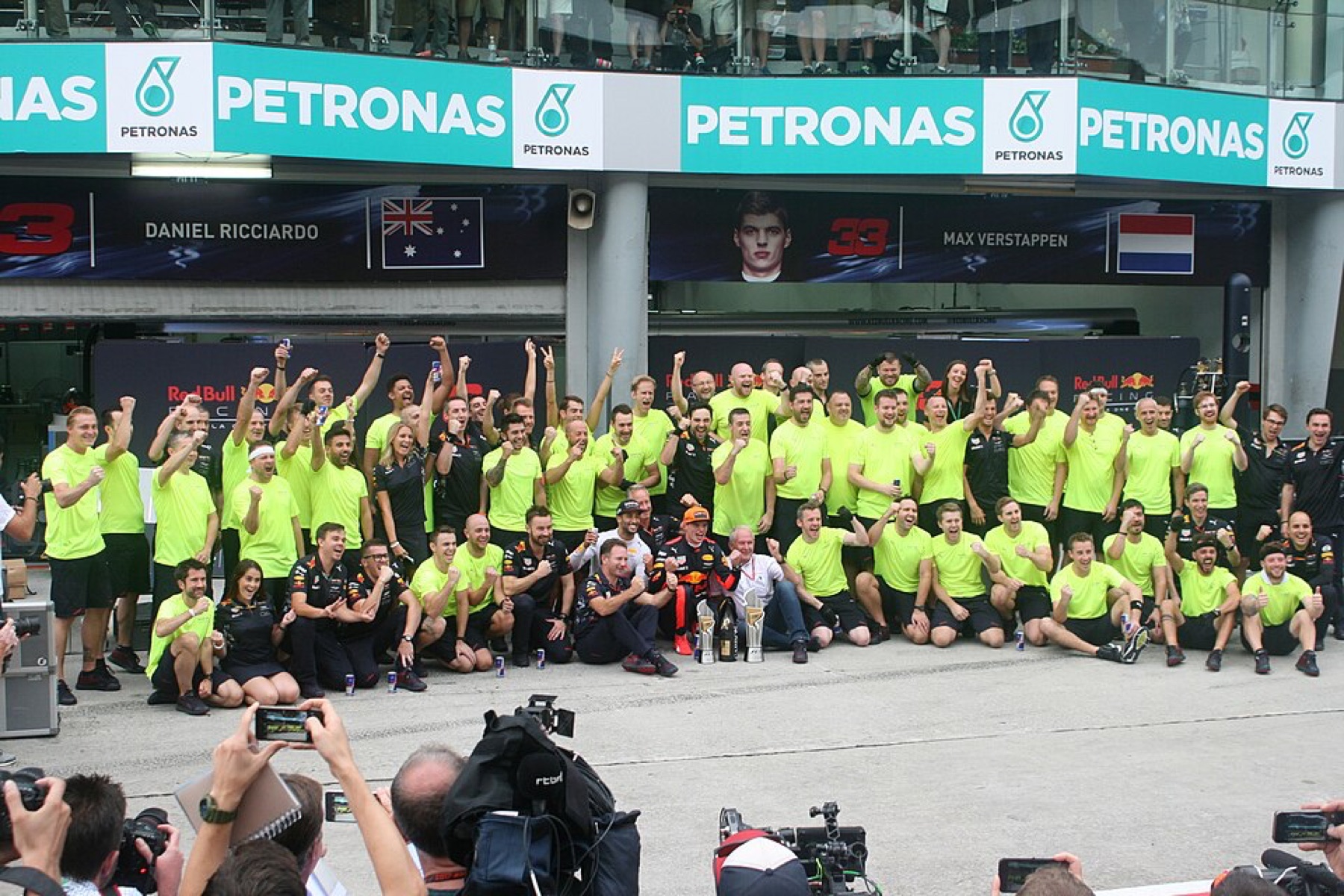 Red Bull Racing team members celebrating with branded apparel visible