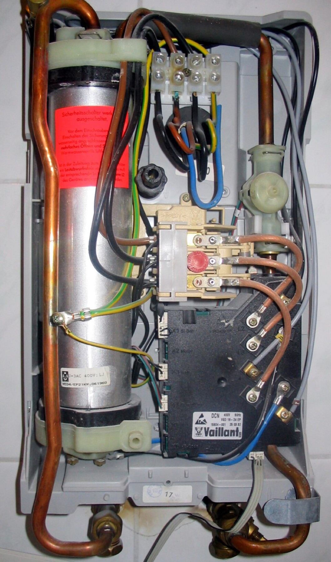 Wall-mounted electric heater unit mounted on a bathroom wall