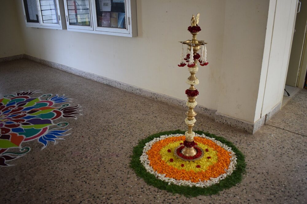 Rose-themed floral decorations lit by a lamp in a dim interior
