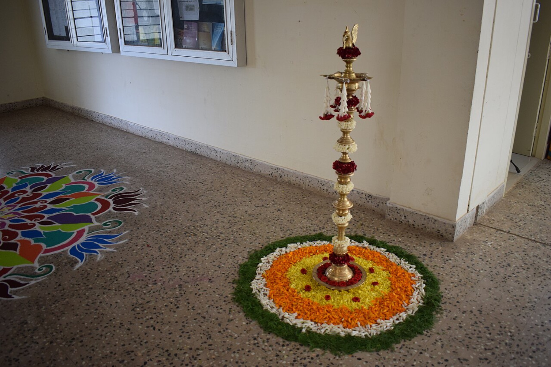 Rose-themed floral decorations lit by a lamp in a dim interior