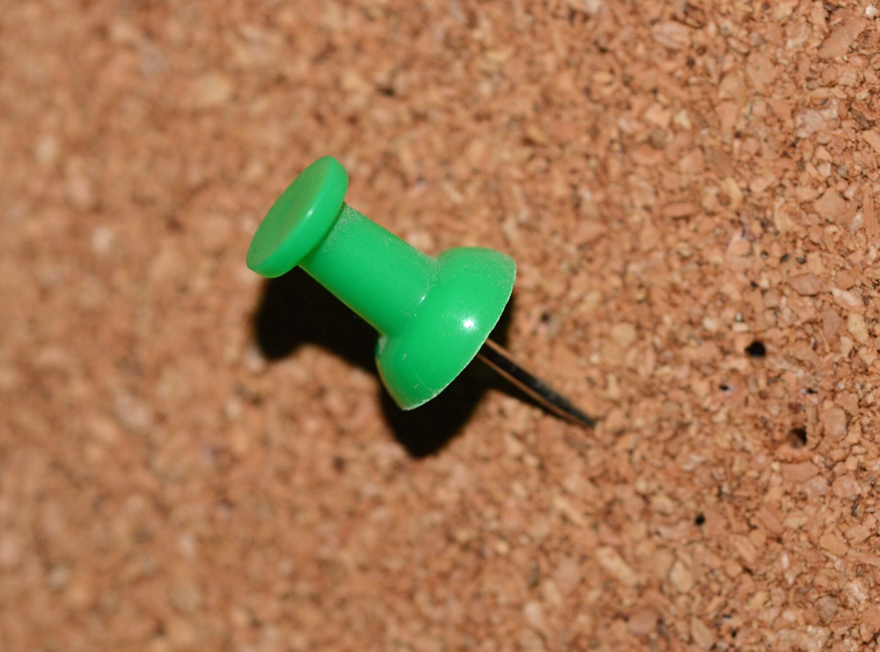 Bulk thumb tack pinned into a cork board