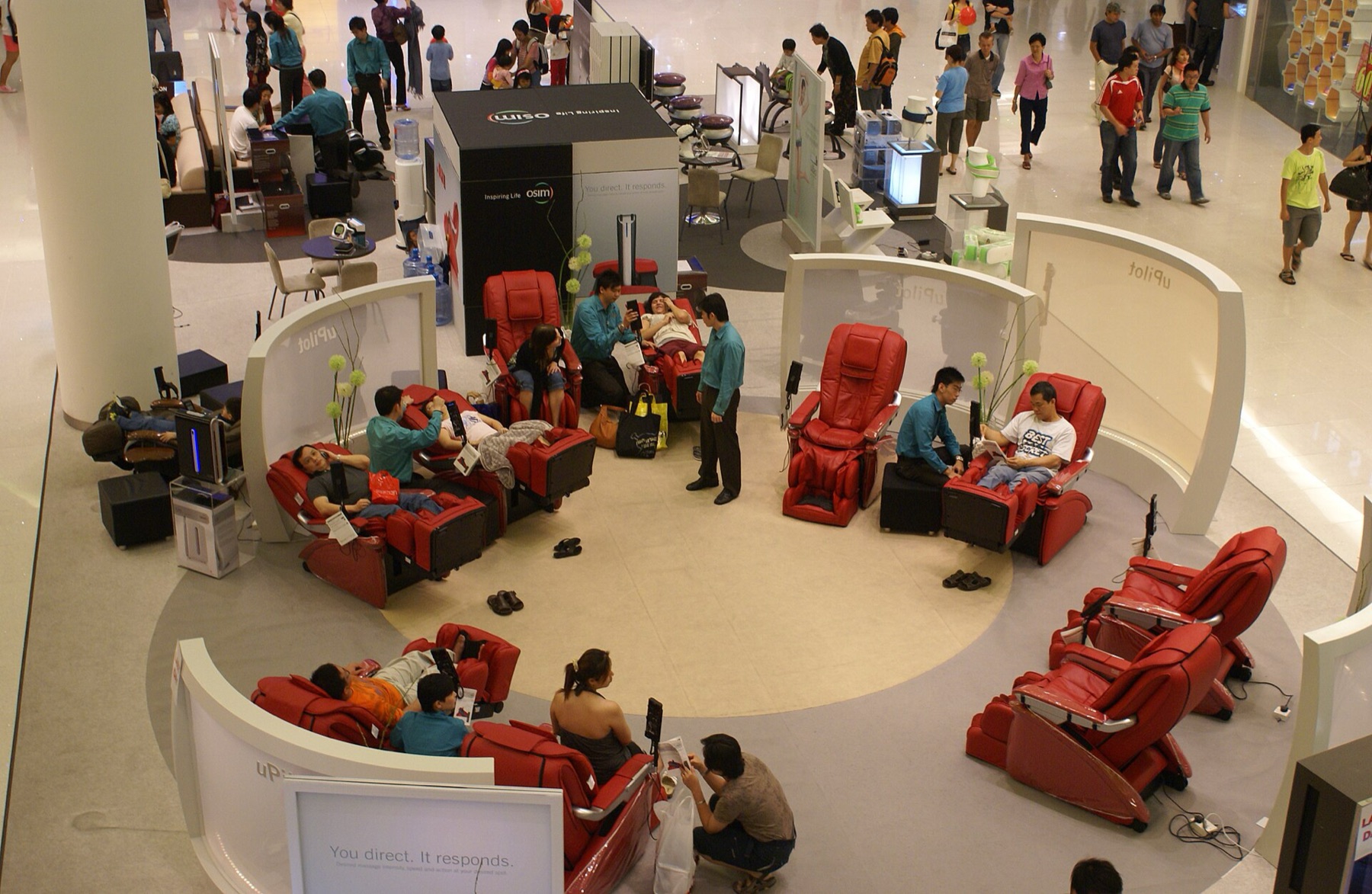 Row of powered massage chairs in a shopping center