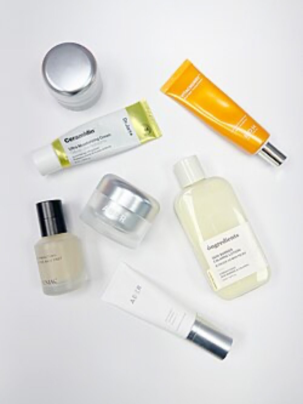 Assorted cosmetic and beauty products laid out on a surface