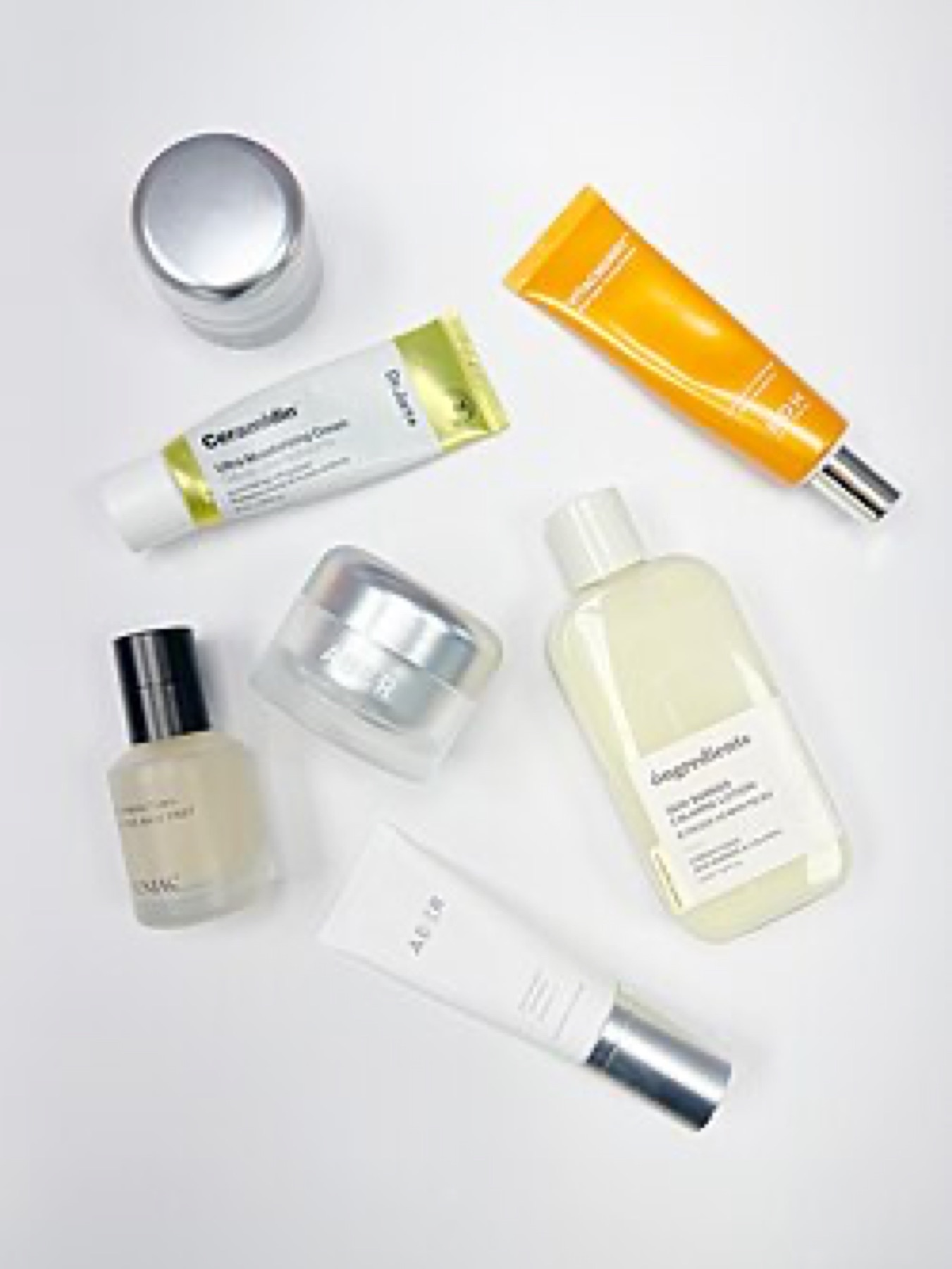 Assorted cosmetic and beauty products laid out on a surface