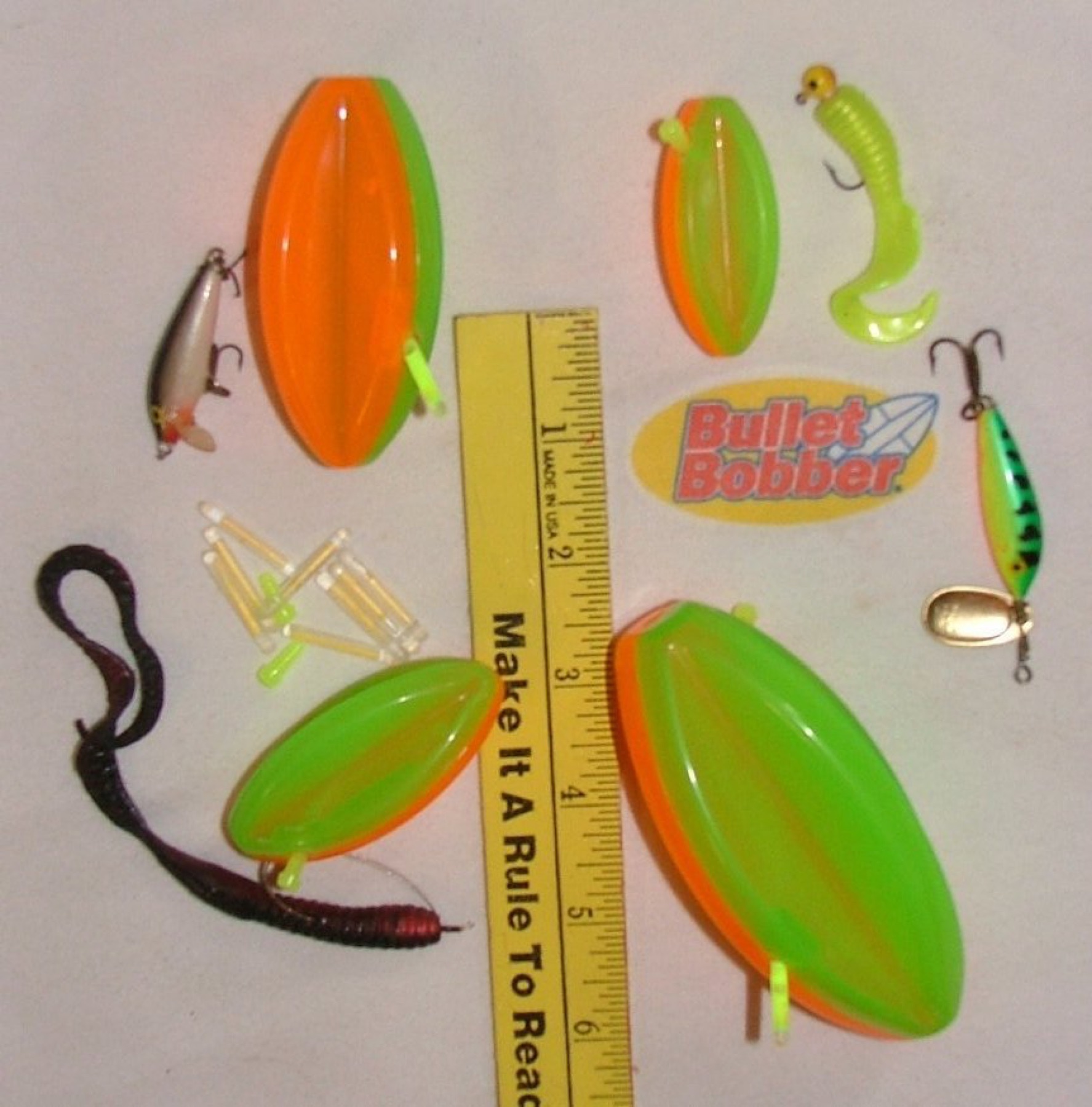 Assorted fishing floats and bobbers in different shapes and colors laid out on a surface