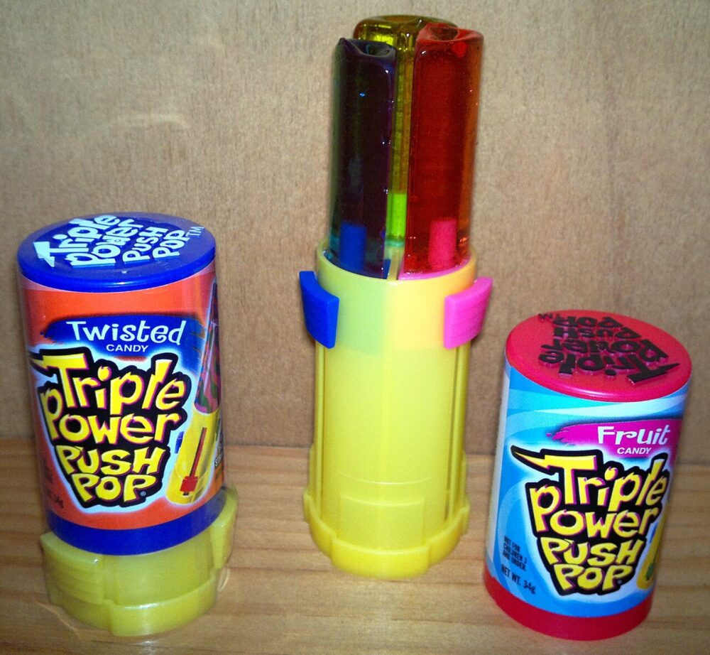 Assorted push pop-style candy tubes on a table