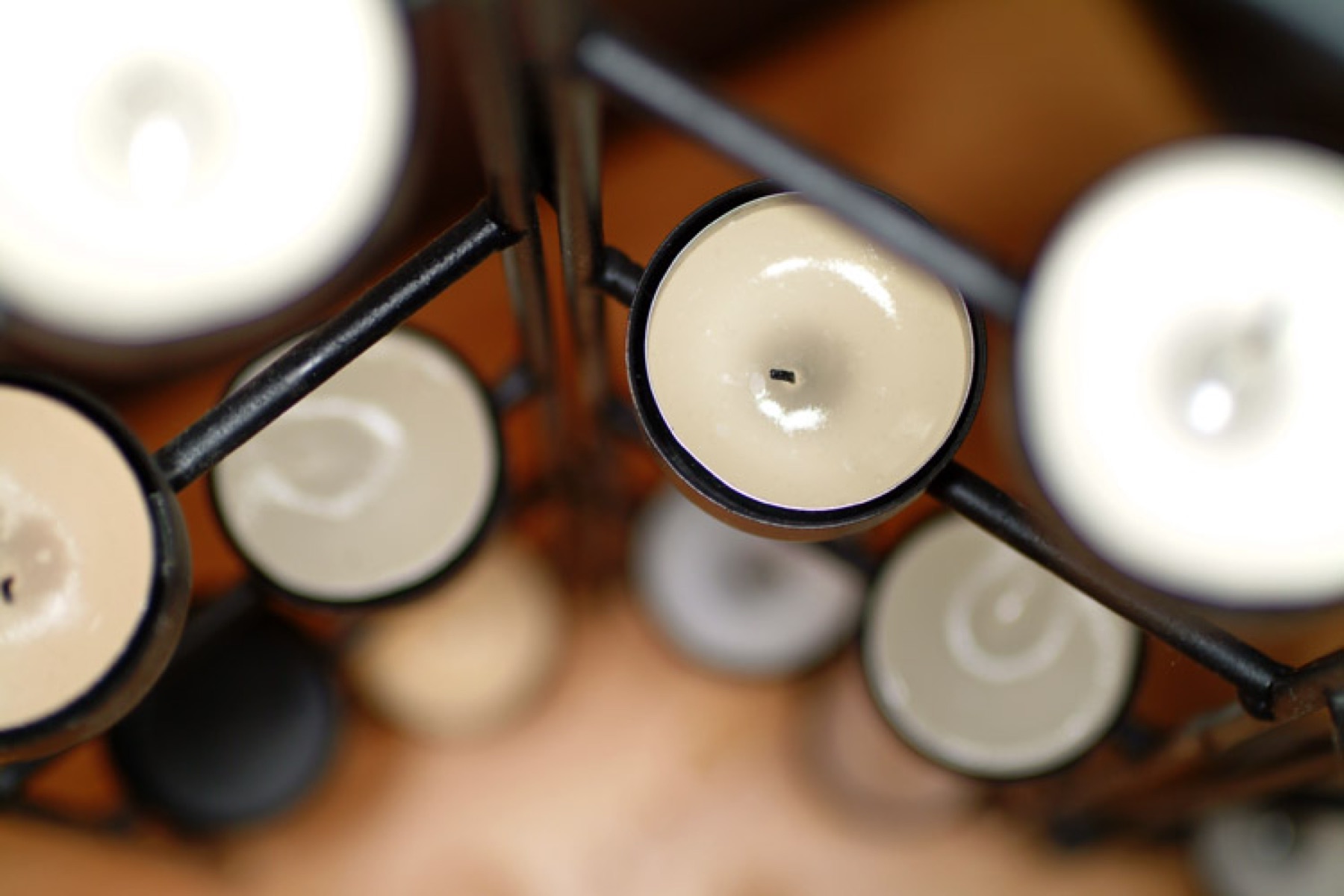 Multiple tealight candles arranged in a purpose-built holder
