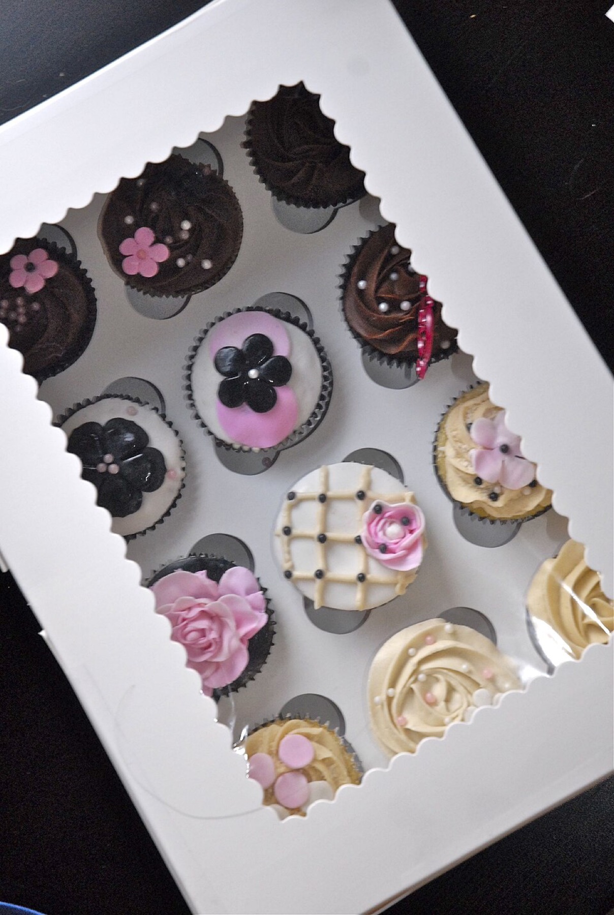 Cupcakes packed in a cardboard box with clear lid
