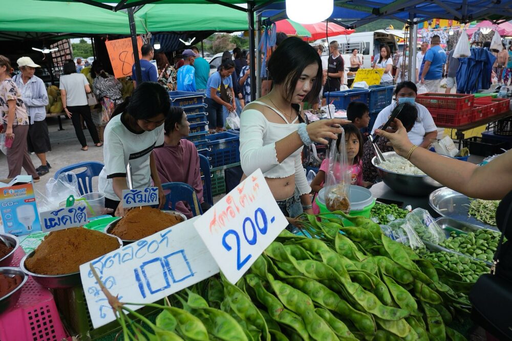Outdoor market with multiple vendor tents and canopies, showing typical booth structures