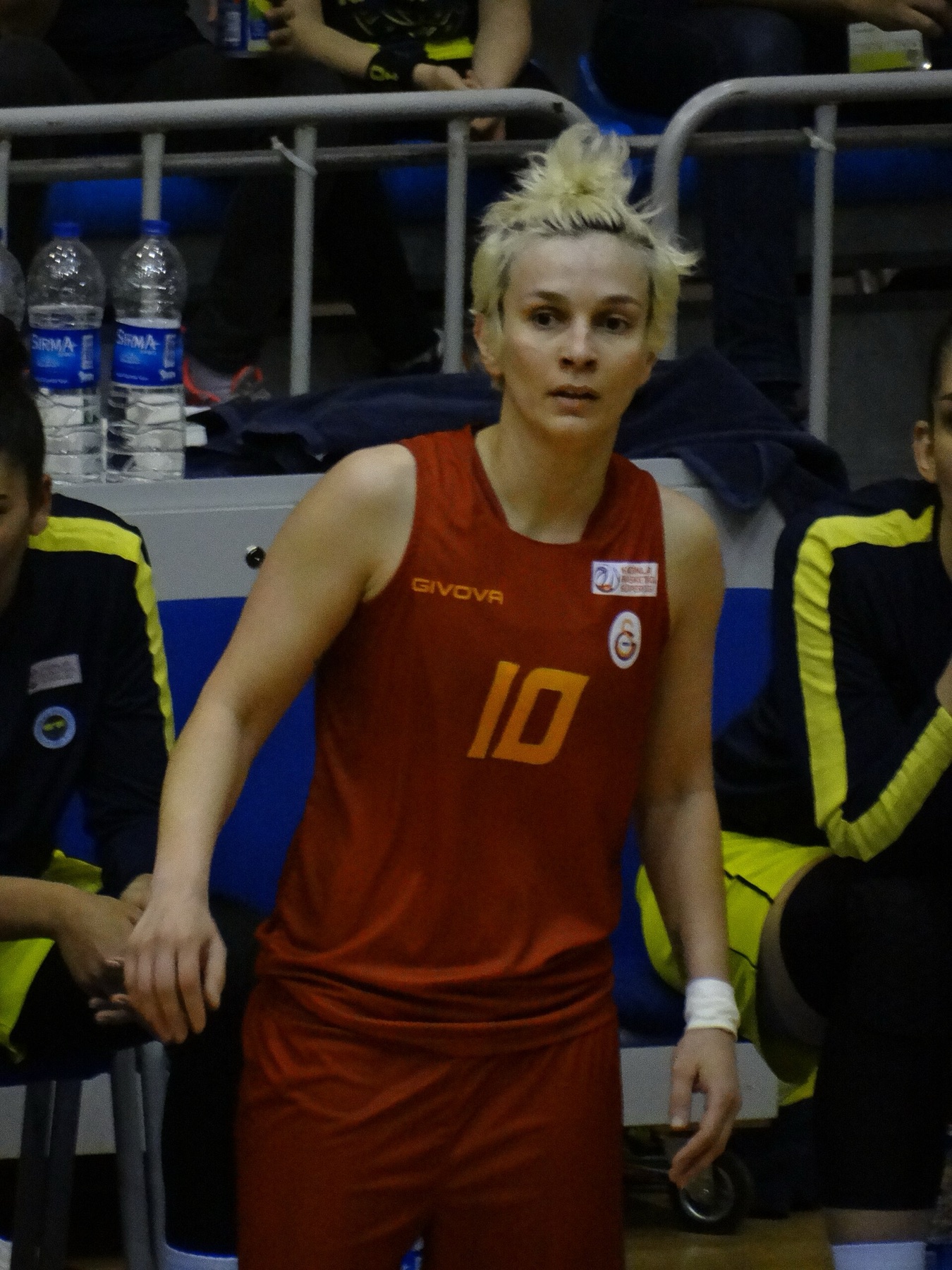 Women’s basketball player in team uniform preparing to shoot, illustrating game-ready jerseys.