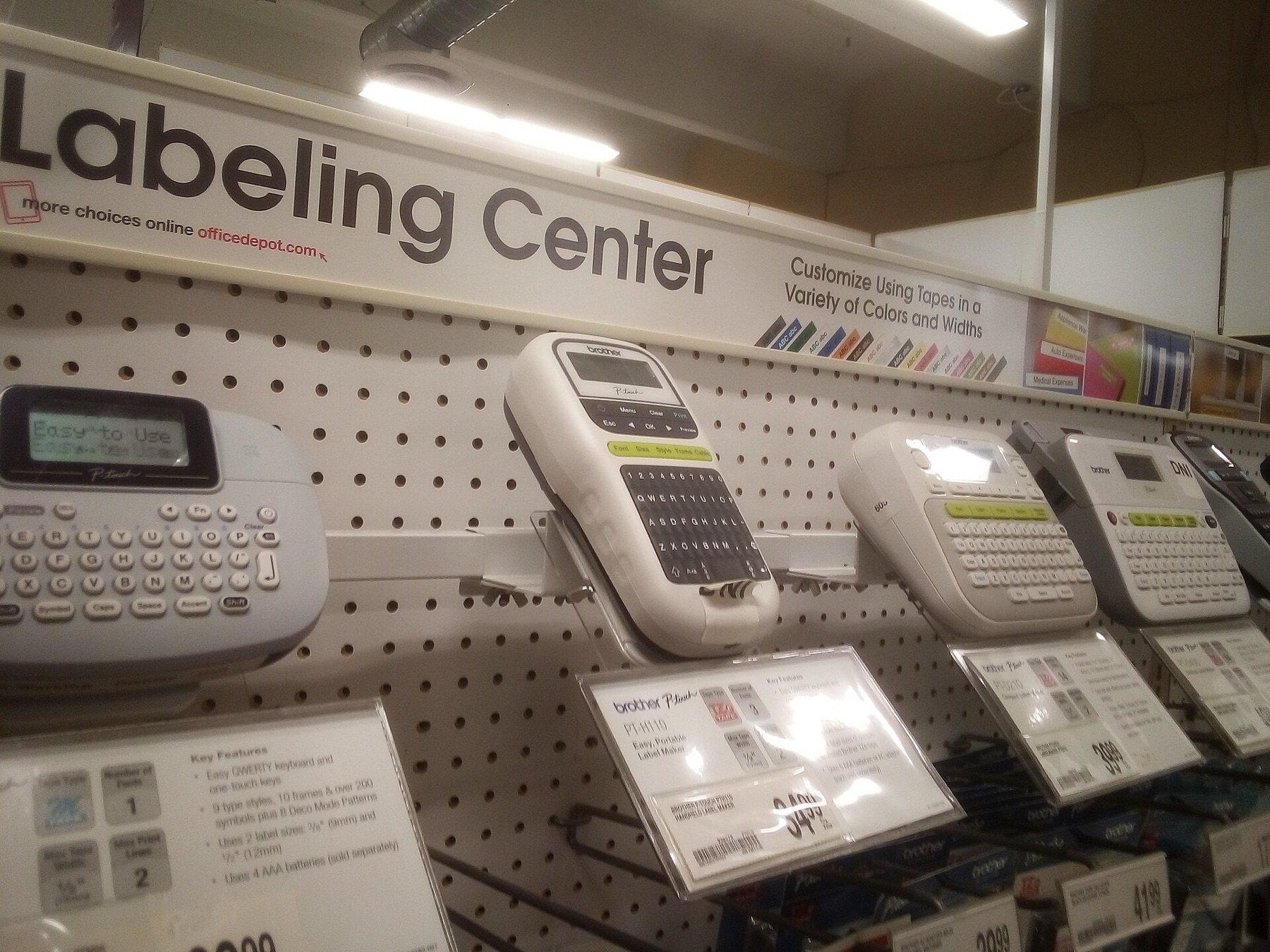 Shelf display of various label makers in an office supply store
