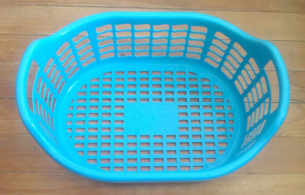 Plastic laundry basket in neutral colour, illustrating rigid laundry storage design