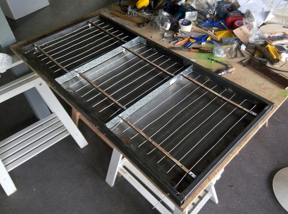 Nichrome wire heating elements assembled in rectangular metal frames on a workshop bench