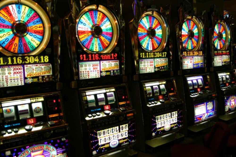 Row of traditional slot machines in a casino environment
