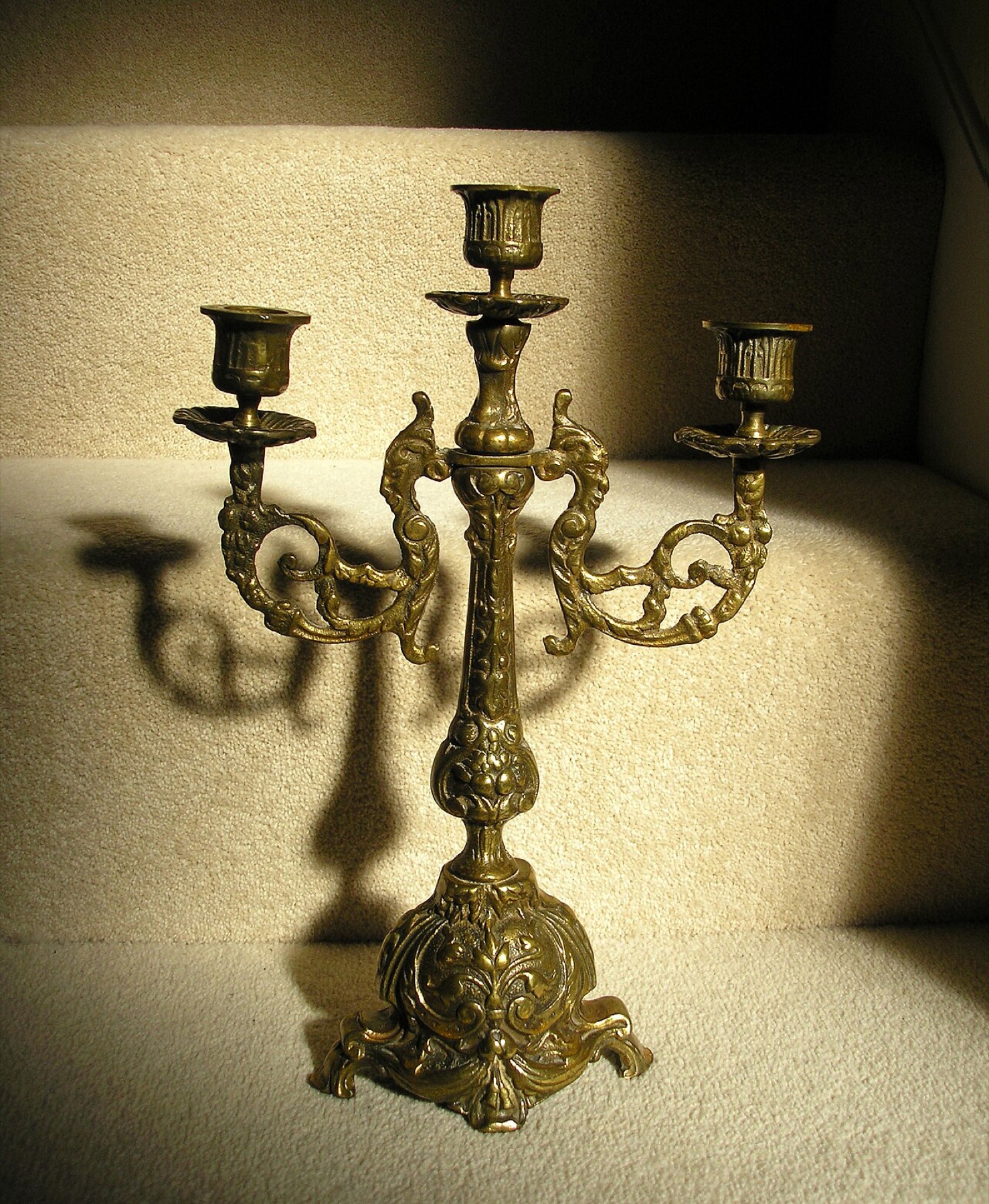 Three-arm brass candelabrum used as a table centerpiece